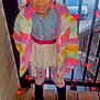 Diamond Civils is registered to the contest to win money with this photo: child, girl, rainbow_jacket, black_boots, heart_patterned_leggings, braided_hair, stairs, wooden_floor, outdoor, railing, car, smiling, portrait, colorful_clothing, winter_clothing, filter, red_hearts, happy, standing, daylight