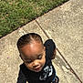 toddler, child, holding_hands, sidewalk, grass, outdoor, sunlight, black_tshirt, jeans, sandals, earrings, hand, tattoo, person, portrait, daylight, curious, walking, cute, small_child