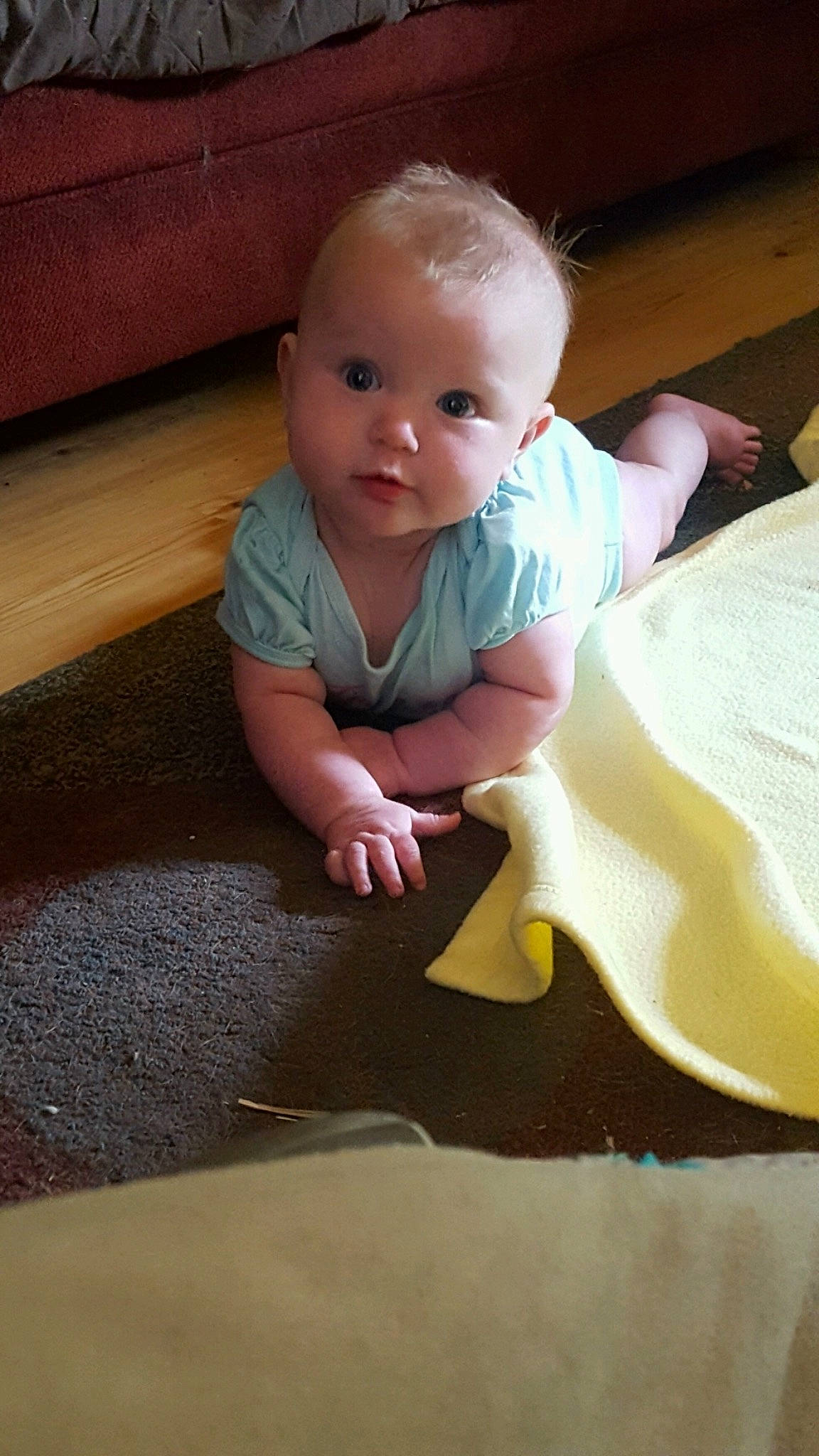 Shay is registered to the contest to win money with this photo: baby, cheek, child, crawling, eye, face, floor, flooring, head, person, play, sitting, skin, toddler, tummy_time