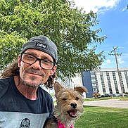 Newyork joined the competition — help win amazing prizes! building, cap, casual, daylight, dog, glasses, grass, happy, leash, man, nature, outdoor, person, pet, portrait, sidewalk, sky, smile, tree, urban
