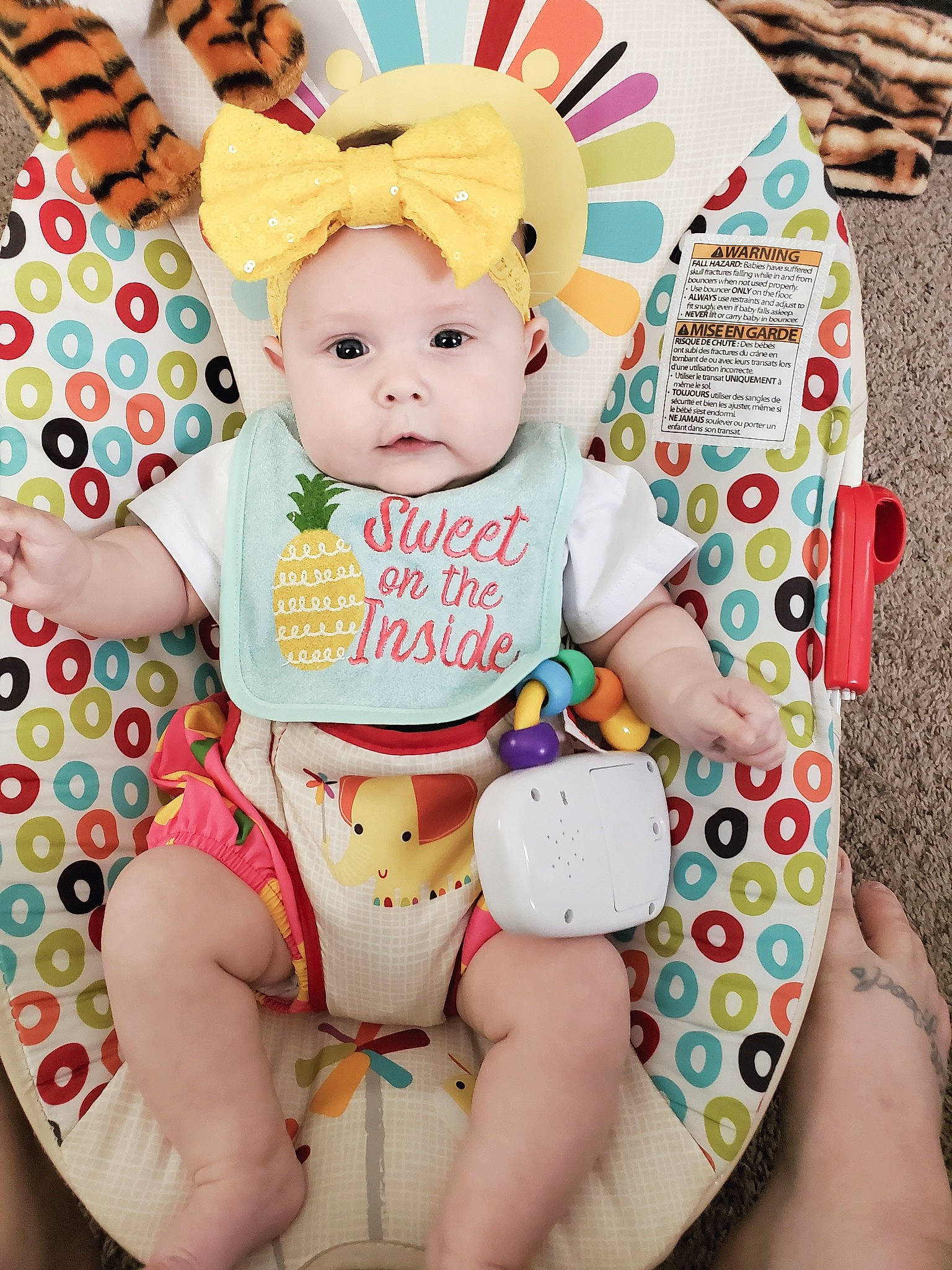 Josephine is registered to the contest to win money with this photo: abdomen, baby, baby_products, baby_toddler_clothing, cheek, child, face, finger, happy, hat, headwear, human_leg, knee, pattern, person, pink, product, sitting, textile, thigh