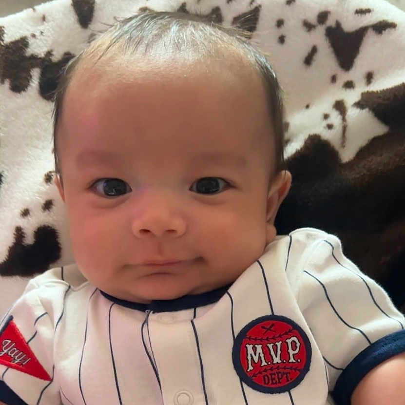 Malykai joined the competition — help win amazing prizes! apparel, baby, blanket, child, clothing, comfort, cute, fabric, face, indoor, infant, pattern, person, portrait, resting, sleeve, smile, soft, striped, young