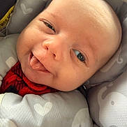 Jax joined the competition — help win amazing prizes! baby, infant, face, tongue, smile, blanket, heart_pattern, cozy, soft, cute, child, closeup, expression, wrapped, warm, newborn, happy, person, indoors, playful