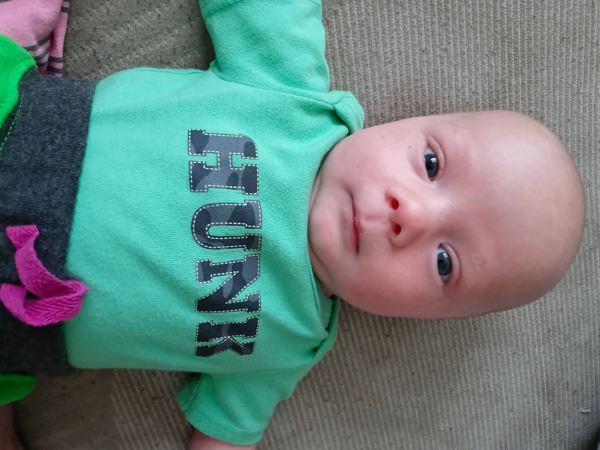 Henry-thomas is registered to the contest to win money with this photo: baby, baby_toddler_clothing, cheek, child, comfort, electric_blue, green, joint, mammal, neck, nose, outerwear, pattern, person, product, skin, sleeve, t_shirt, textile, toddler