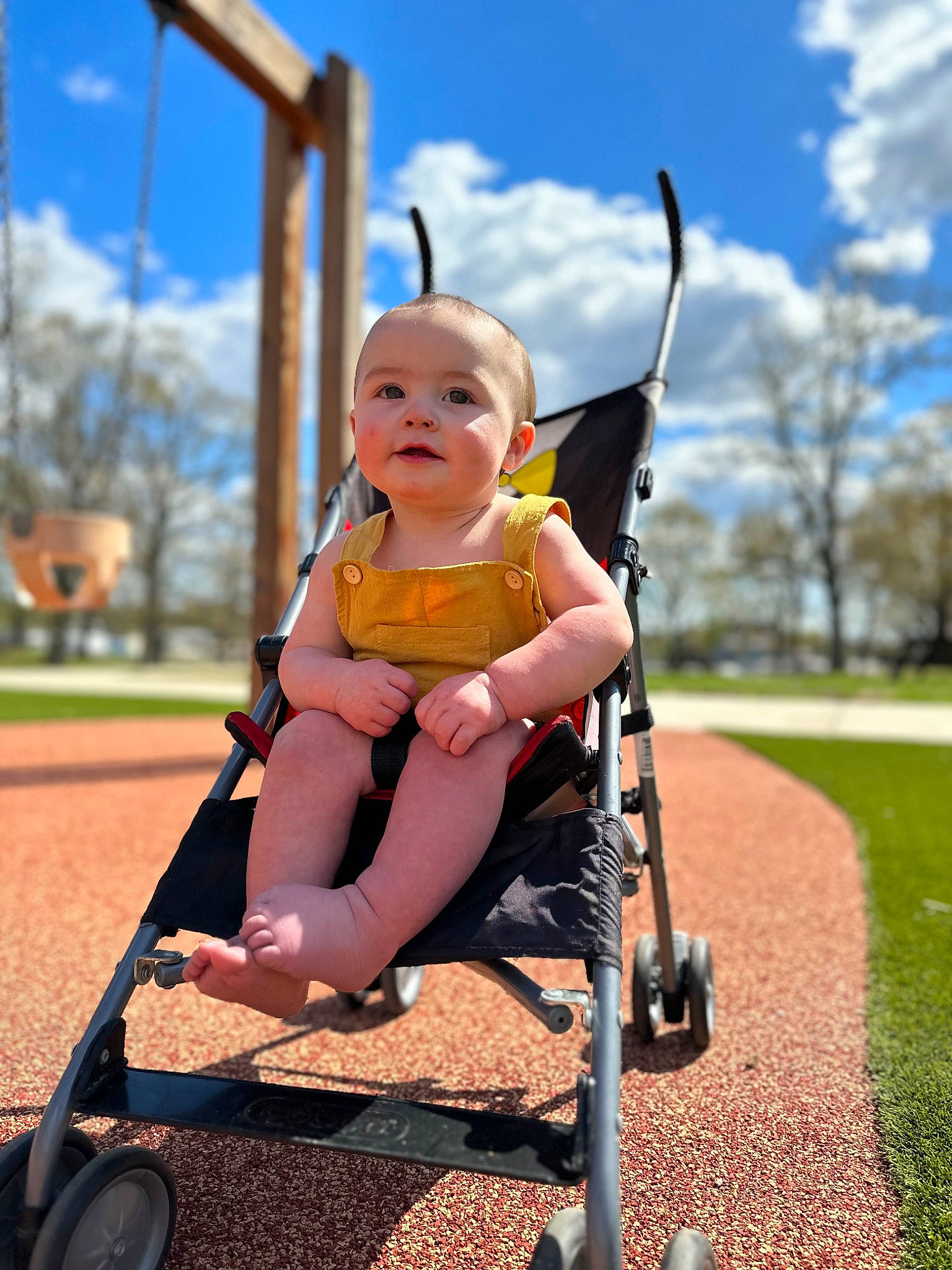 Nash is registered to the contest to win money with this photo: baby, baby_carriage, baby_products, baby_toddler_clothing, child, city, cloud, fun, grass, happy, leisure, outdoor_play_equipment, people_in_nature, person, playground, recreation, sky, swing, tire, toddler