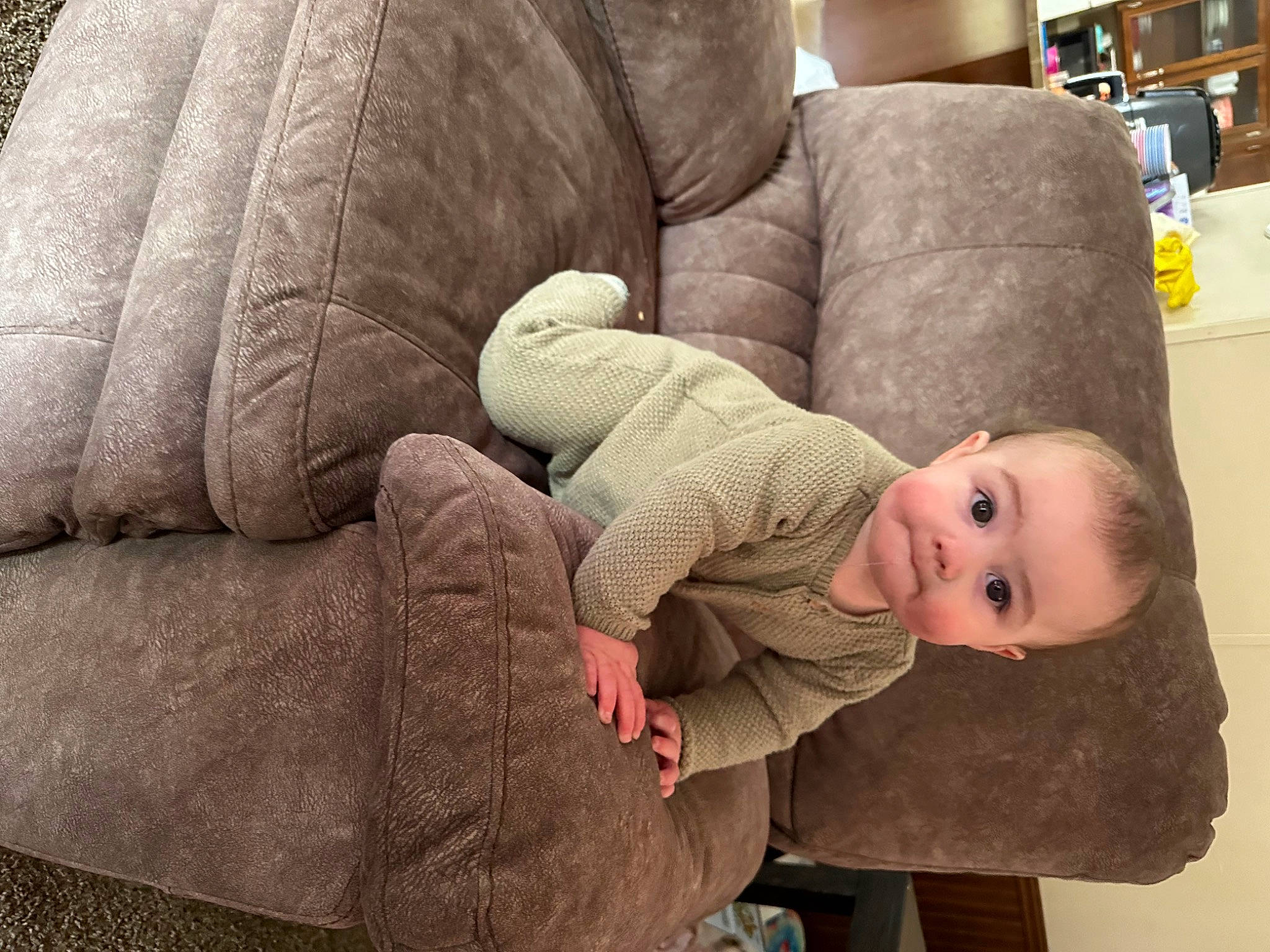 Nash joined the competition — help win amazing prizes! armrest, baby, baby_products, baby_toddler_clothing, bookcase, cheek, child, comfort, couch, flooring, living_room, person, room, shelf, shelving, sitting, sleeper_chair, sleeve, sofa_bed, surprise