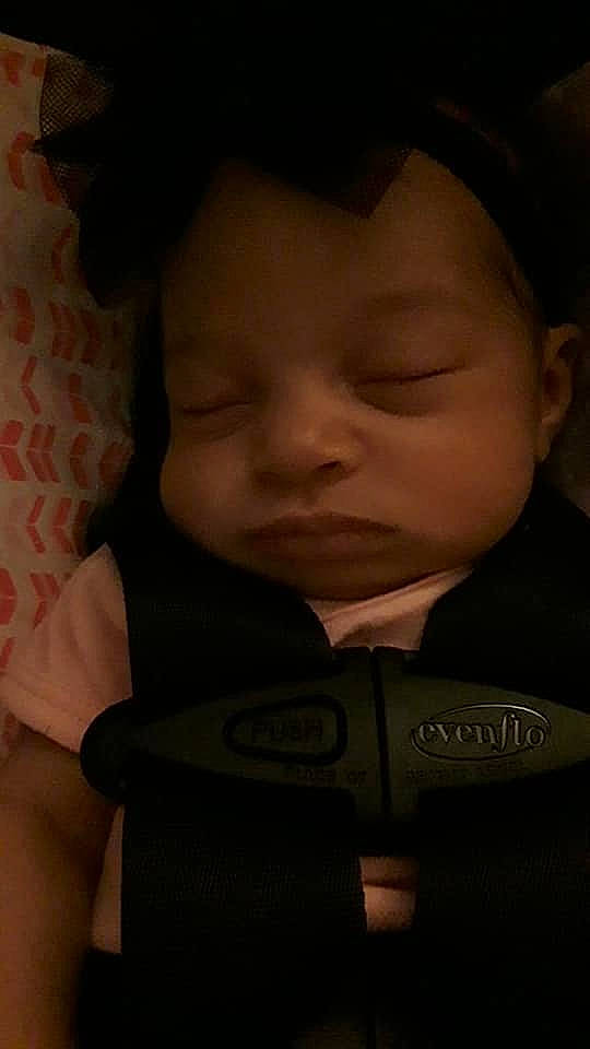 Nuri is registered to the contest to win money with this photo: baby, black, cheek, child, darkness, ear, eye, face, forehead, head, lip, mouth, nose, person, photography, skin, sleep, smile, toddler