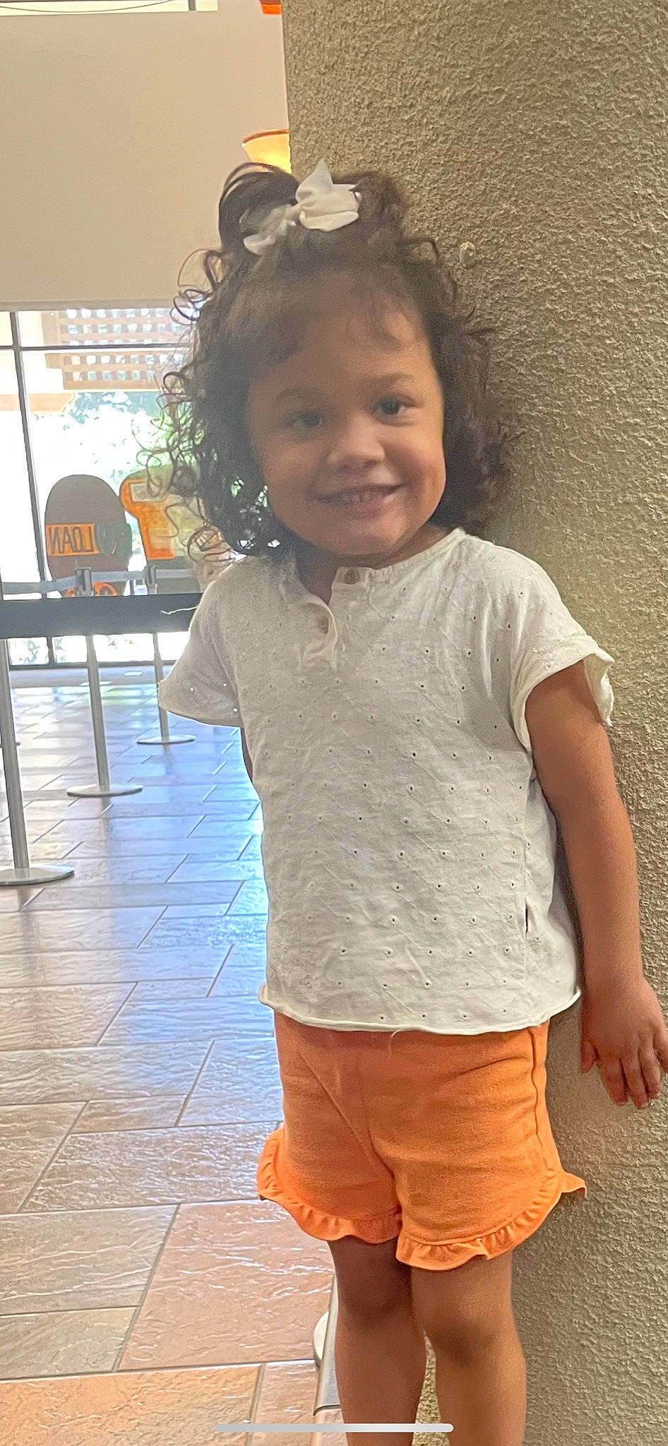 Hollyn is registered to the contest to win money with this photo: child, face, facial_expression, fun, gesture, hairstyle, happy, joint, joy, neck, nose, organ, outerwear, person, shoulder, skin, sleeve, smile, t_shirt, toddler