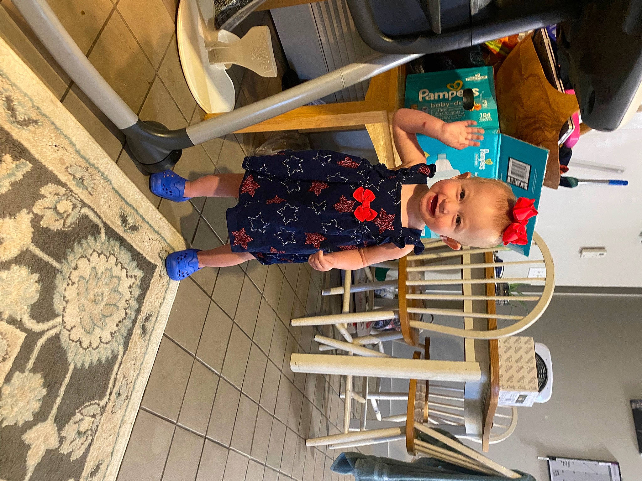 Kylee is registered to the contest to win money with this photo: automotive_exterior, child, dress, fun, hat, human_leg, joy, leisure, pattern, person, room, t_shirt, tire, toddler, trunk, vehicle_door