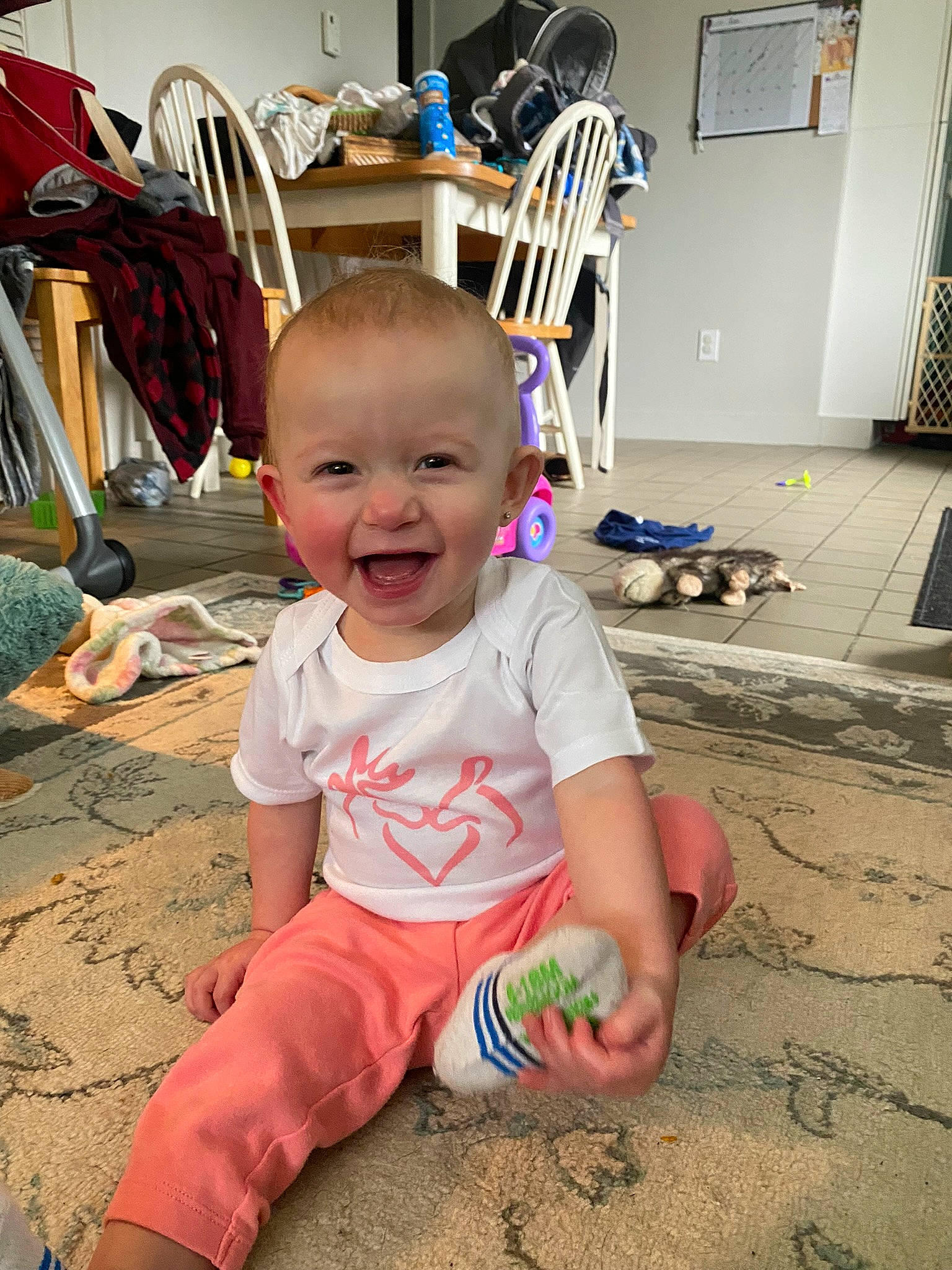 Kylee is registered to the contest to win money with this photo: baby, baby_toddler_clothing, chair, child, door, floor, flooring, foot, fun, happy, hardwood, mammal, people_in_nature, person, play, sitting, skin, smile, standing, toddler