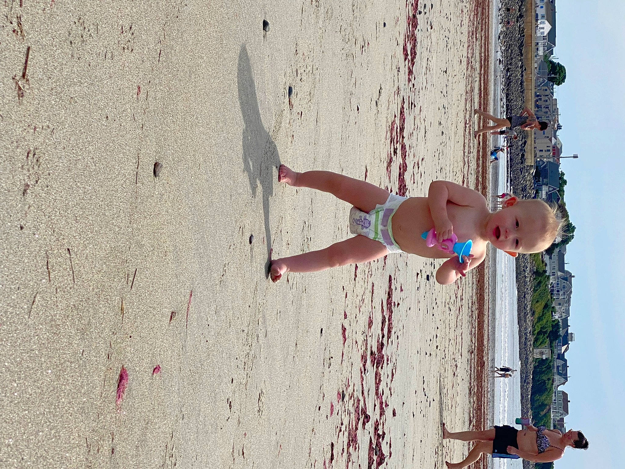 Kylee joined the competition — help win amazing prizes! azure, barechested, barefoot, beach, elbow, foot, fun, human_leg, leg, leisure, people_on_beach, person, recreation, sand, sky, sun_tanning, thigh, wall, water, wheel