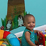 Xzavion joined the competition — help win amazing prizes! toddler, child, smiling, toy, colorful, onesie, indoor, playtime, baby, mural, wall_painting, bunny, greenery, floor, soft_toys, piano_toy, cute, happy, person, room