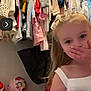 Walker joined the competition — help win amazing prizes! child, girl, dress, clothing, hanger, closet, toy, pink_basket, indoor, face, hand, covering_mouth, video_call, curtain, woman, person, room, colorful, furniture, casual