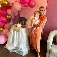 Sawyer Blake joined the competition — help win amazing prizes! baby, woman, birthday_cake, high_chair, balloons, party, celebration, dress, smile, indoor, flooring, decorations, pink, gold, white, fabric, crown, person, glasses, happy