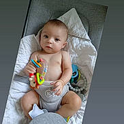 Zarek a rejoint le concours — aidez-le/la à gagner de superbes lots ! baby, blanket, child, clothing, colorful, comfort, cushion, cute, expression, face, hand, indoor, infant, person, playful, quilt, seat, soft, toy, young