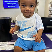 Makias joined the competition — help win amazing prizes! toddler, child, smiling, nike, white_tshirt, blue_shorts, store, counter, technology, electronics, indoor, person, portrait, cute, young_child, retail, shop, happy, casual_clothing, seated