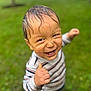 Gabriel is registered to the contest to win money with this photo: toddler, child, smiling, wet_hair, dirty_face, thumbs_up, outdoor, grass, greenery, striped_shirt, happy, portrait, cute, playful, young_child, nature, casual_clothing, daylight, closeup, person