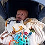 baby, blanket, stroller, toy, happy, smiling, child, infant, cozy, comfort, colorful, outdoor, hand, face, clothing, seat, play, cute, young, wrapped