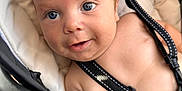 Yariel is registered to the contest to win money with this photo: baby, infant, face, blue_eyes, smile, car_seat, straps, skin, closeup, cute, child, seatbelt, comfort, young, person, human, baby_boy, expression, indoors, portrait