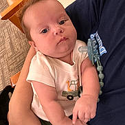 Yariel joined the competition — help win amazing prizes! baby, infant, child, person, arms, clothing, pacifier, giraffe, shirt, indoor, carpet, hand, face, cute, skin, holding, people, young, newborn, comfort