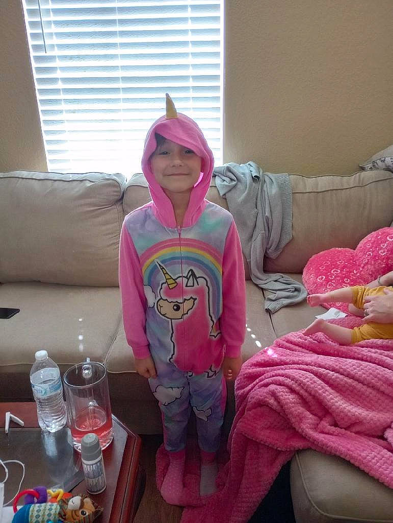 Rayleigh joined the competition — help win amazing prizes! bottled_water, cap, comfort, couch, distilled_water, drinking_water, event, fun, headwear, joy, magenta, mammal, person, pink, room, sleeve, smile, t_shirt, textile, toddler