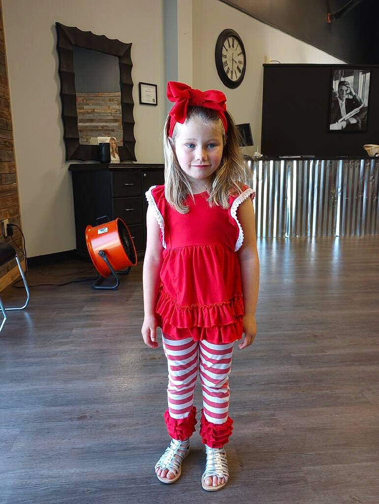 Brinley is registered to the contest to win money with this photo: baby_toddler_clothing, carmine, chair, clock, costume, event, fashion_design, flooring, fun, hardwood, holiday, human_leg, joy, knee, luggage_and_bags, magenta, pattern, person, sleeve, sock