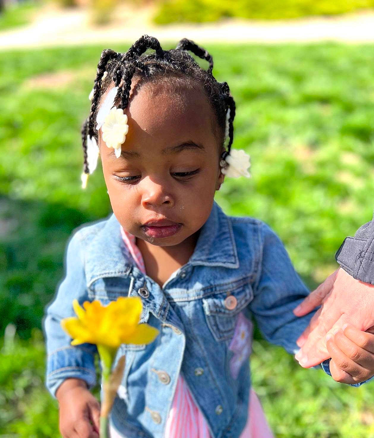 Zaylani joined the competition — help win amazing prizes! botany, child, clothing, facial_expression, flower, flowering_plant, fun, gesture, grass, grass_family, happy, iris, leaf, meadow, people_in_nature, person, petal, plant, sitting, spring
