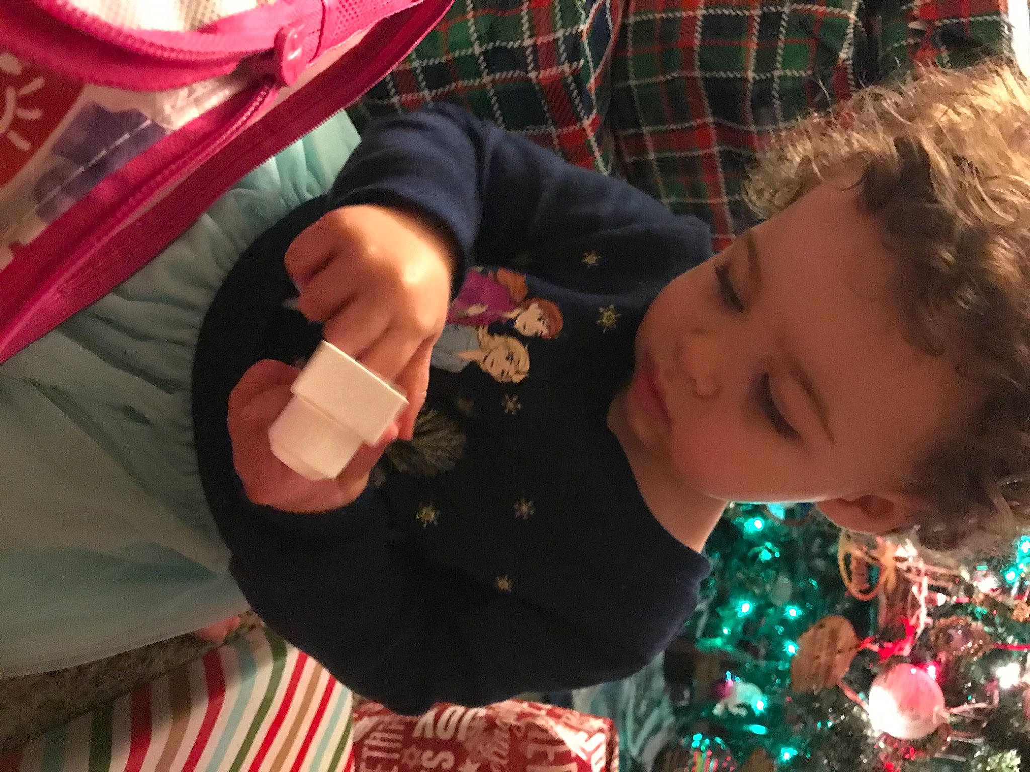 Everly joined the competition — help win amazing prizes! child, christmas_decoration, christmas_ornament, christmas_tree, event, fun, happy, holiday, leisure, nail, ornament, pattern, person, plaid, recreation, sitting, smile, tartan, toddler, tradition