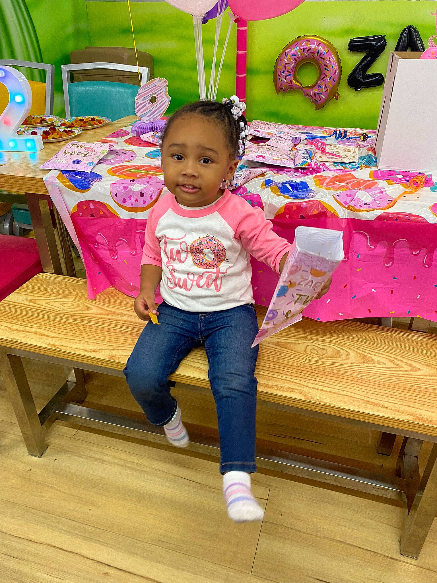 Zariah is registered to the contest to win money with this photo: baby_toddler_clothing, balloon, chair, child, event, flooring, fun, furniture, green, happy, hardwood, leisure, magenta, person, pink, sharing, sitting, table, toddler, wood
