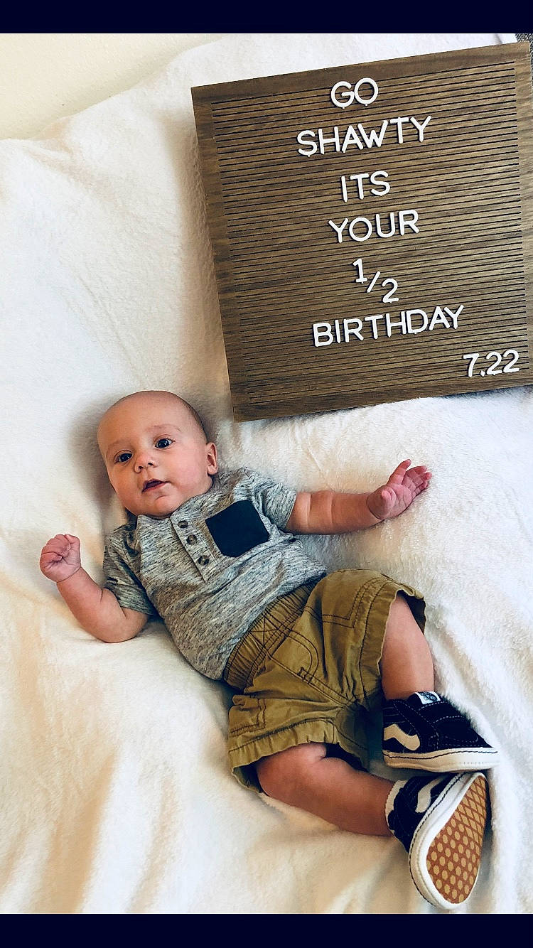 Kenneth joined the competition — help win amazing prizes! baby, baby_toddler_clothing, child, comfort, facial_expression, finger, font, hand, happy, leg, linens, pattern, person, room, sitting, skin, sleeve, sock, textile, toddler