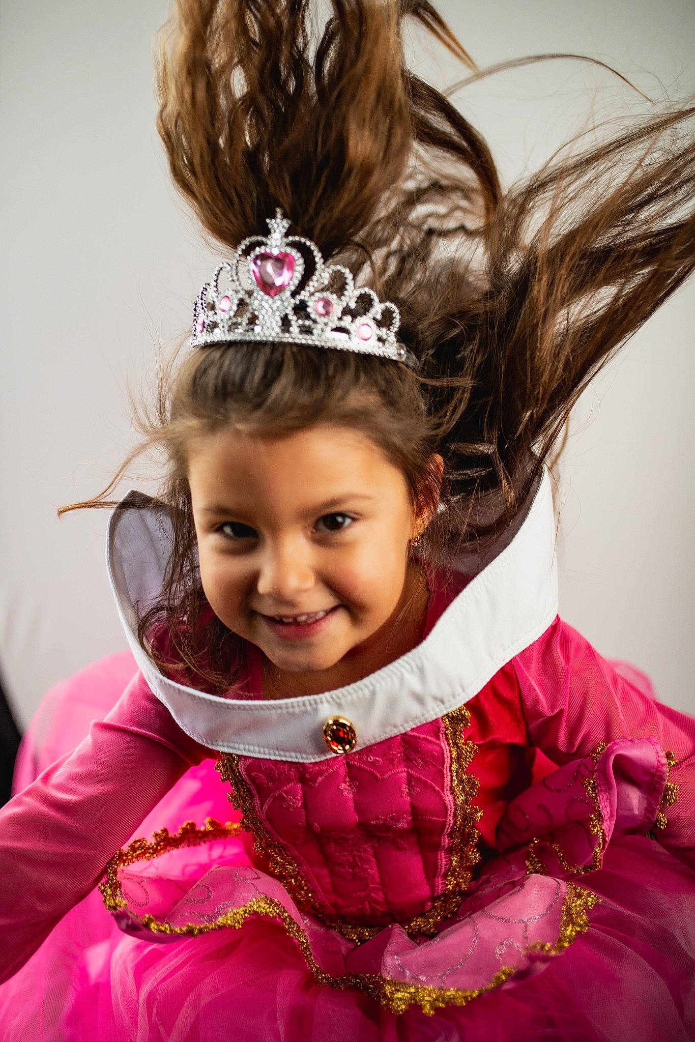 Maëlia a rejoint le concours — aidez-le/la à gagner de superbes lots ! brown_hair, child, child_model, costume, crown, dress, fashion_accessory, hair, hair_accessory, hairstyle, head, headband, headgear, headpiece, joy, long_hair, magenta, person, pink, smile