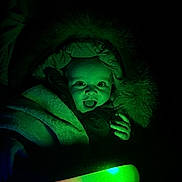 Alfie joined the competition — help win amazing prizes! baby, child, coat, colorful_light, cute, dark, expression, face, fur, glow, hand, happy, hood, infant, light_stick, night, portrait, surprised, warm, winter_clothing