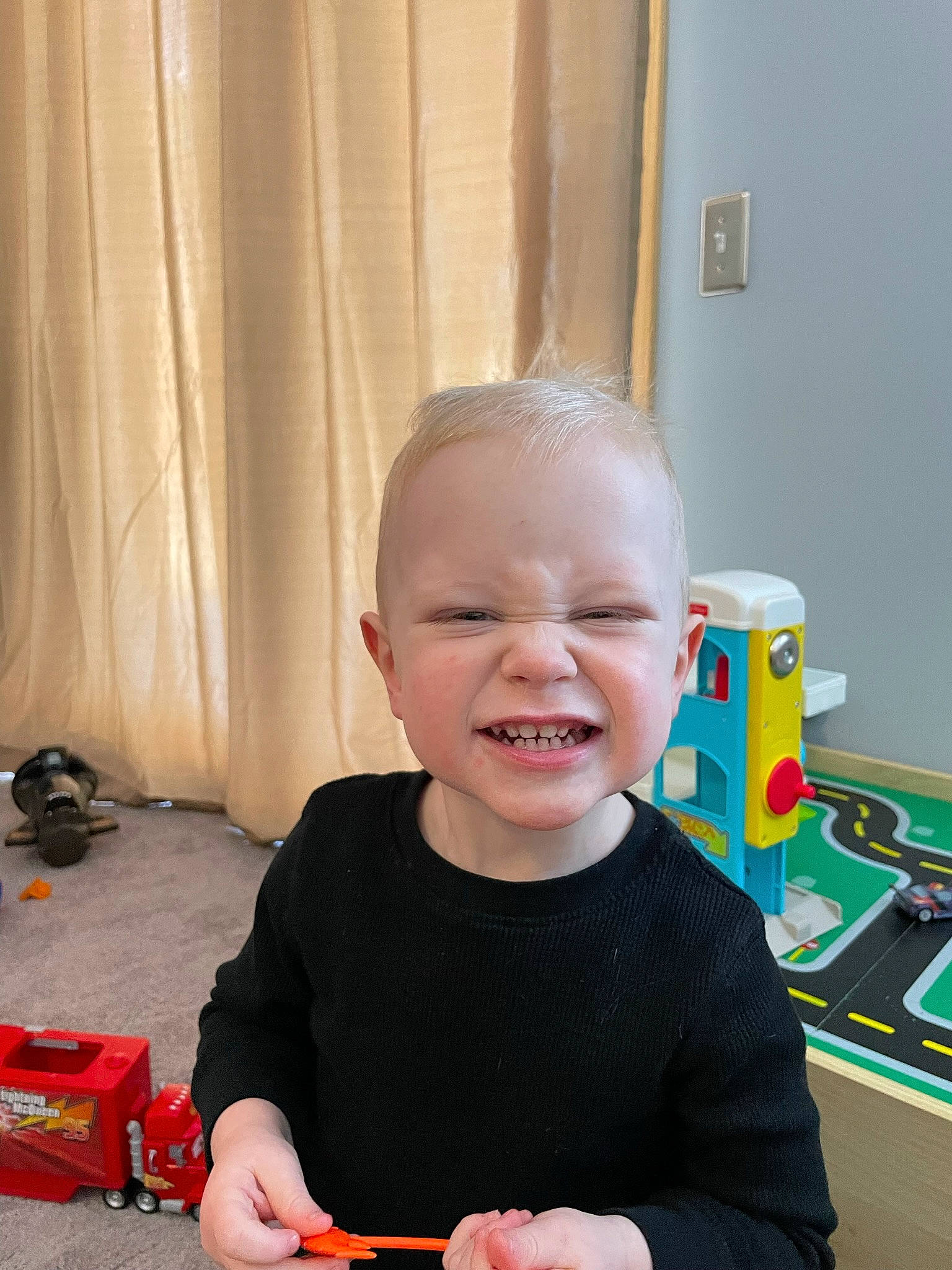 Dexter is registered to the contest to win money with this photo: baby, baby_playing_with_toys, baby_products, baby_toddler_clothing, baby_toys, bag, child, curtain, fun, happy, joy, laugh, luggage_and_bags, person, play, room, sitting, smile, t_shirt, toddler