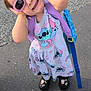 Ahsoka-Aline participe au concours pour gagner de l'argent avec cette photo : accessory, backpack, casual, child, cute, dress, fashion, footwear, hands, happy, outdoor, pavement, person, playful, purple, smile, summer, sunglasses, toddler, young