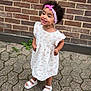 Emily Sophia participe au concours pour gagner de l'argent avec cette photo : brick_wall, casual, child, curly_hair, cute, fashion, floral_dress, happy, headband, outdoor, pavement, person, playful, portrait, smiling, standing, summer, toddler, white_sandals, young_child