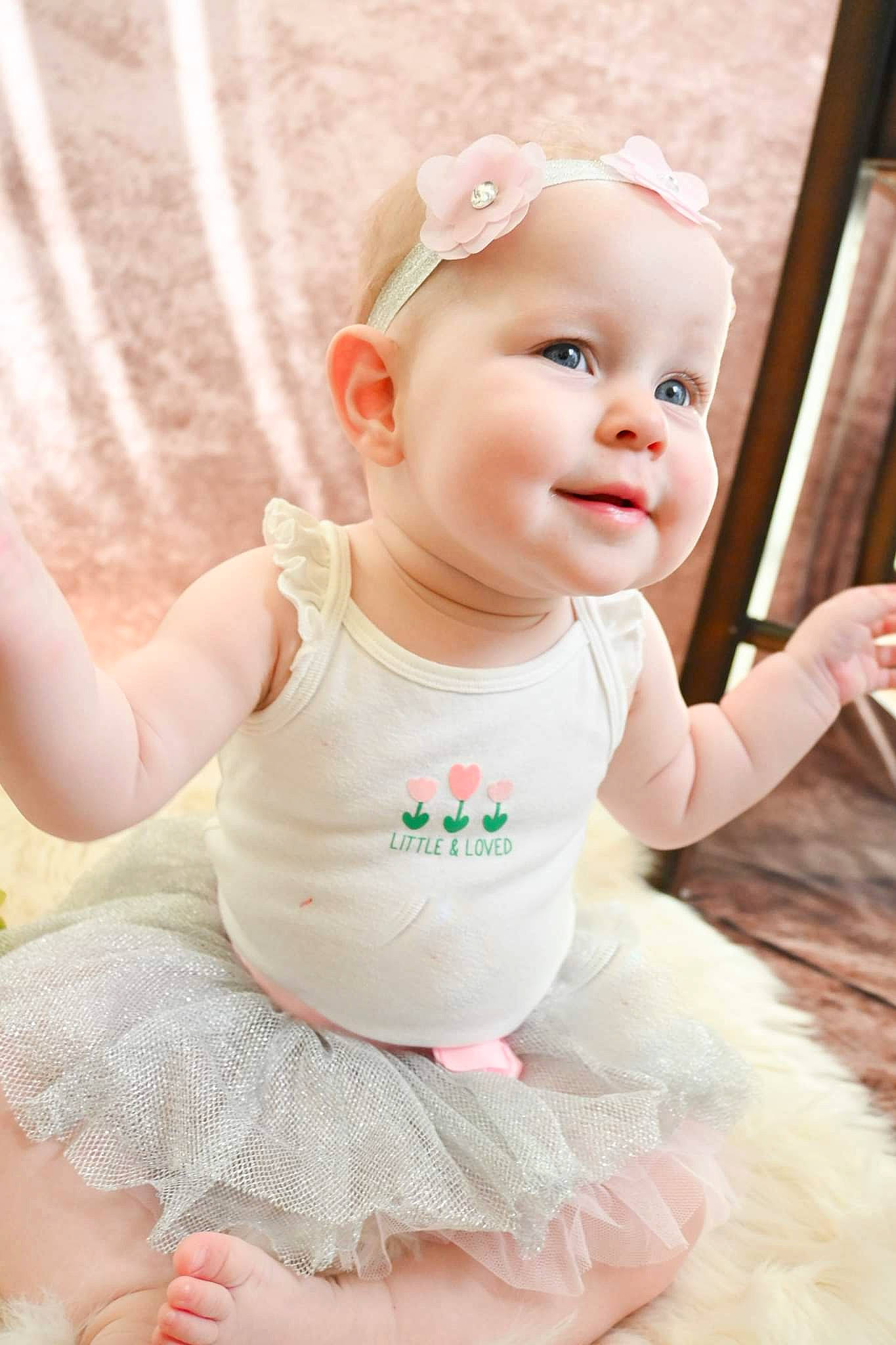 Belle joined the competition — help win amazing prizes! baby, baby_toddler_clothing, cheek, child, embellishment, fashion_accessory, flash_photography, fun, grass, happy, hat, headgear, person, pink, sitting, skin, sleeve, smile, t_shirt, toddler