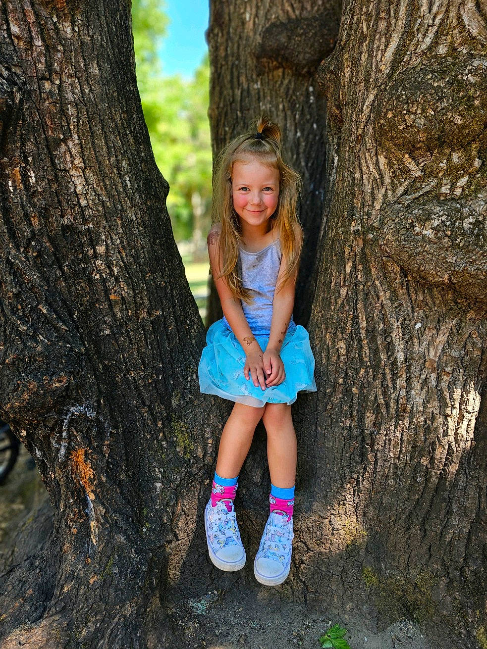 Emma joined the competition — help win amazing prizes! adaptation, azure, botany, branch, facial_expression, forest, grass, happy, joy, leg, morning, natural_environment, people_in_nature, person, plant, smile, standing, sunlight, tree, trunk