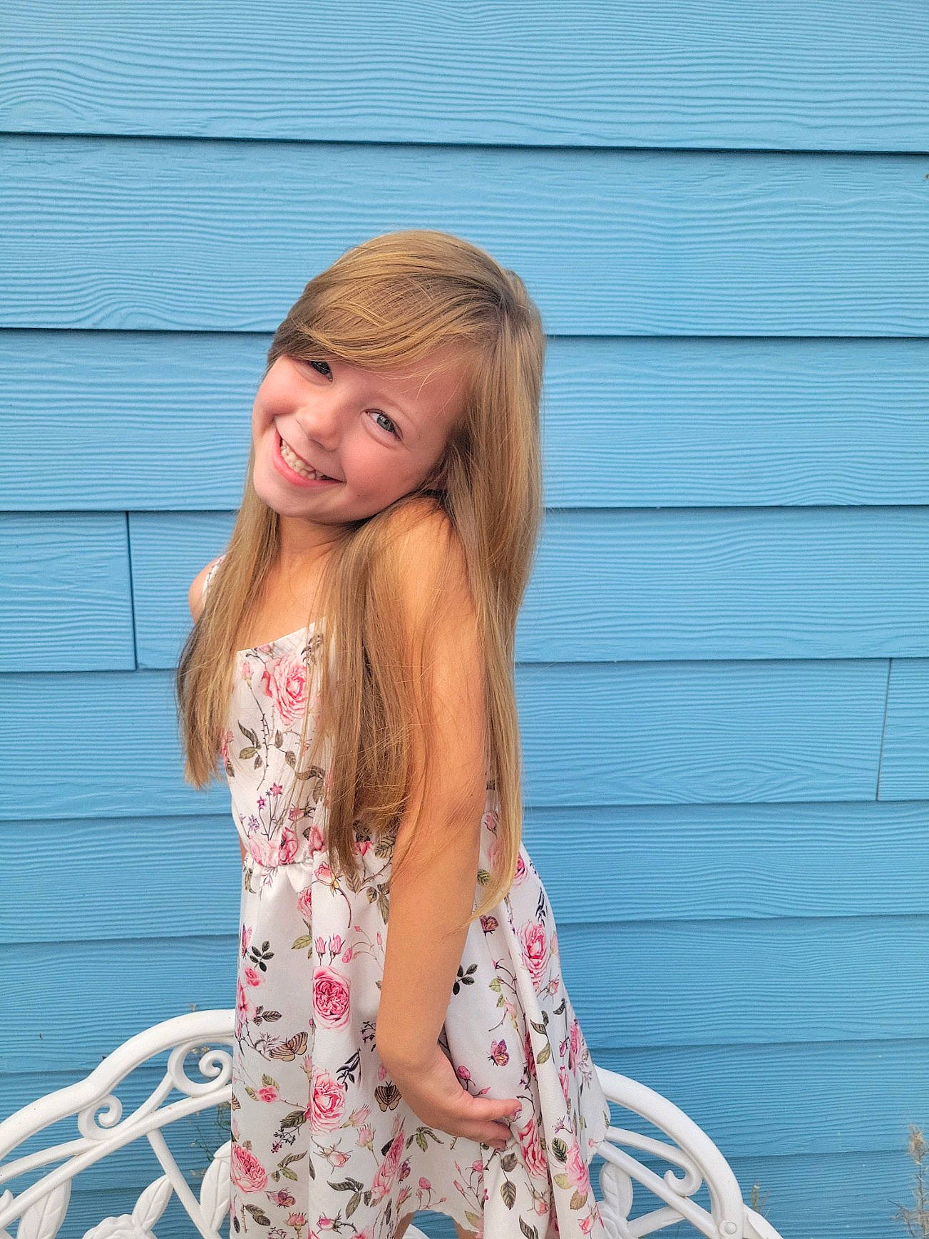 Emma joined the competition — help win amazing prizes! bangs, blond, brown_hair, clothing, dress, electric_blue, grass, happy, human_leg, joy, layered_hair, magenta, pattern, peach, people_in_nature, person, pink, sitting, sleeve, smile