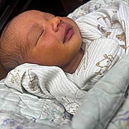 Freya is registered to the contest to win money with this photo: newborn, baby, sleeping, smiling, blanket, wrapped, infant, soft, cute, peaceful, closeup, face, portrait, cozy, indoors, child, young, resting, warm, adorable