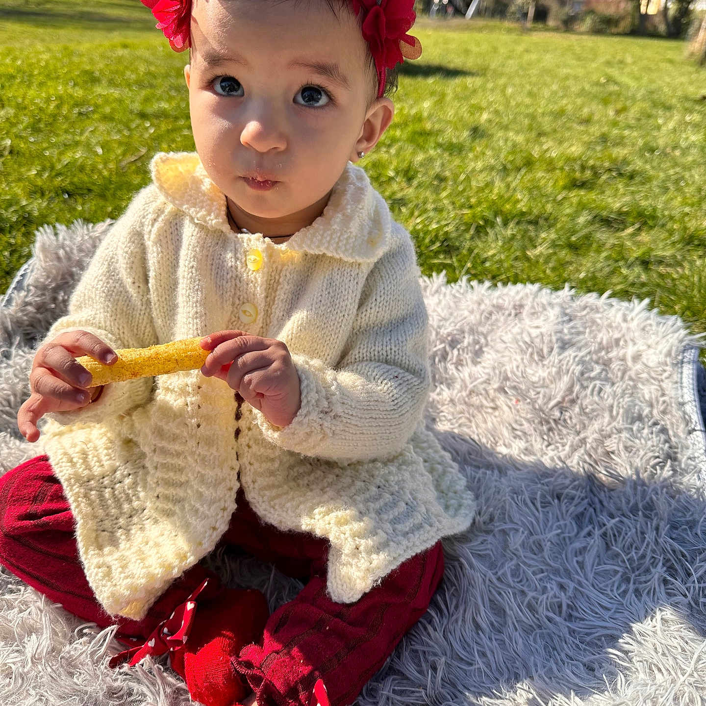 Gagandeep is registered to the contest to win money with this photo: baby, bodypart, clothing, costume, dress, face, finger, flower, food, grass, hand, hat, head, knitwear, person, photography, plant, portrait, sitting, sweater