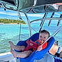 Finn joined the competition — help win amazing prizes! baby, child, swing, boat, water, ocean, sea, blue, sky, sunny, outdoor, smiling, seat, rope, nature, island, vacation, summer, happy, infant