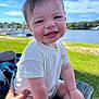 baby, child, smiling, outdoor, grass, water, lake, sky, clouds, person, hand, wood, bench, sunlight, tshirt, happy, portrait, nature, summer, daytime