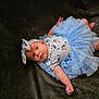 adorable, baby, blanket, blue_tutu, child, clothing, cute, expression, face, headband, human, indoor, infant, lying_down, newborn, one_person, pink_skin, portrait, soft_texture, young_child