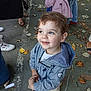child, toddler, smiling, blue_eyes, hoodie, jacket, autumn_leaves, outdoor, pavement, people, shoes, casual_clothing, happy, cute, portrait, standing, looking_up, daylight, young_child, street