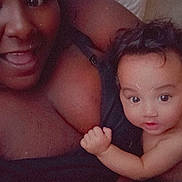 Solara-Avalon is registered to the contest to win money with this photo: adult, baby, blanket, clothing, closeup, face, family, happy, indoor, infant, intimate, person, portrait, smiling, skin, toddler, touching, warm, woman, young_child