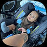 Kamari is registered to the contest to win money with this photo: baby, bicycle_wheel, black, blanket, blue, camouflage, car_seat, child, clothing, cute, expression, gray, hand, indoor, infant, mittens, person, portrait, seat, tattoo