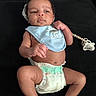 baby, infant, diaper, bib, pacifier, clothing, skin, face, hand, foot, lying_down, black_background, cute, child, newborn, expression, indoors, person, young, resting