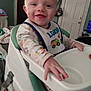 Addison joined the competition — help win amazing prizes! baby, high_chair, smiling, indoor, bib, clothing, hand, face, person, furniture, door, television, bag, toy, blanket, happy, child, room, infant, portrait
