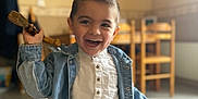 Adriano a rejoint le concours — aidez-le/la à gagner de superbes lots ! boy, casual_clothing, chair, child, cute, denim_jacket, furniture, happy, indoor, jeans, kitchen, laughing, person, playing, portrait, smiling, table, tile_floor, white_shirt, wooden_object