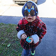 Grayson is registered to the contest to win money with this photo: child, toddler, sunglasses, novelty_sunglasses, cat_ears, hoodie, plaid_coat, red_coat, toy, sidewalk, grass, sneakers, shoes, car, reflection, photographer, portrait, outdoor, cold_weather, cute